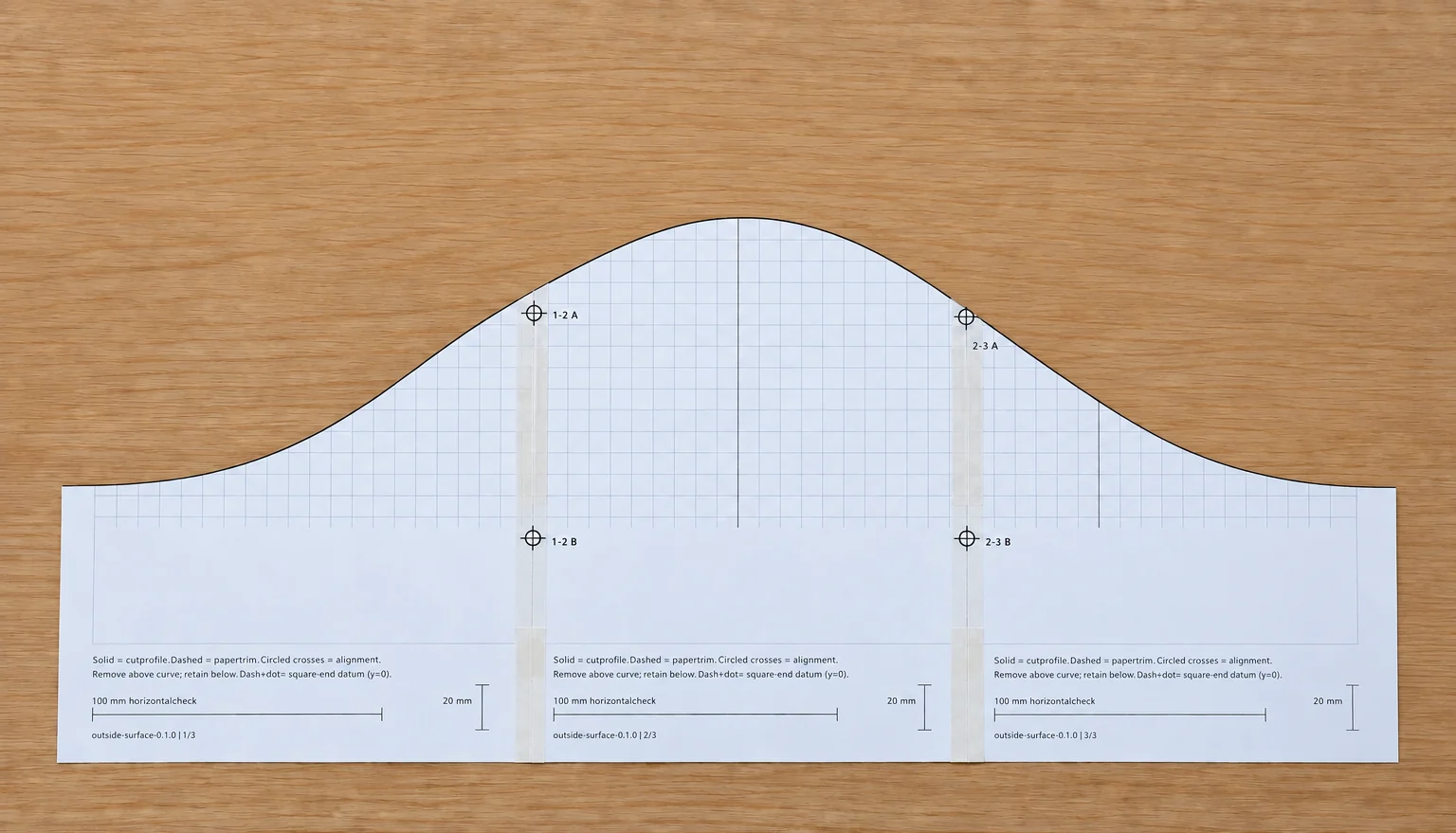Assembled paper template cut along its solid curved profile